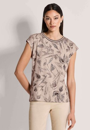 Beige blouse met korte mouwen en zwart bladmotief, ronde halslijn en gladde stof. Effen zoom met subtiele designdetails.