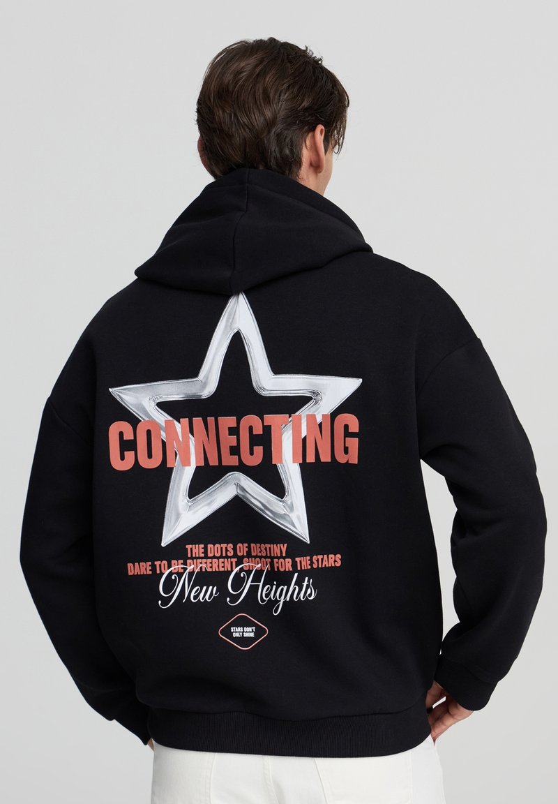 Felpa nera con cappuccio caratterizzata da una grande grafica di una stella bianca sul retro, la scritta "CONNECTING" in corallo e frasi decorative. Tessuto morbido con una vestibilità comoda.