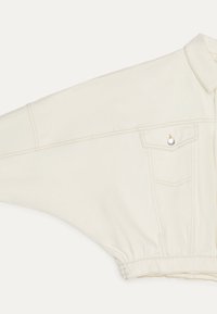 Off-white long-sleeve cotton shirt with wide batwing sleeve, chest pocket with button flap, and elastic waistband.