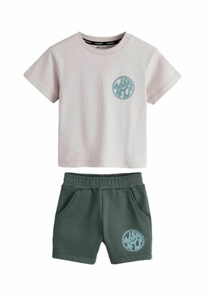 Short-sleeve beige top and green elastic-waist shorts set, each with a circular blue graphic logo on the left side.