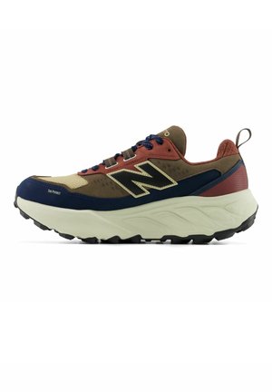 Brown, navy, and rust running shoe with thick white sole, black outsole, laces, and large "N" logo on side with toe protection.
