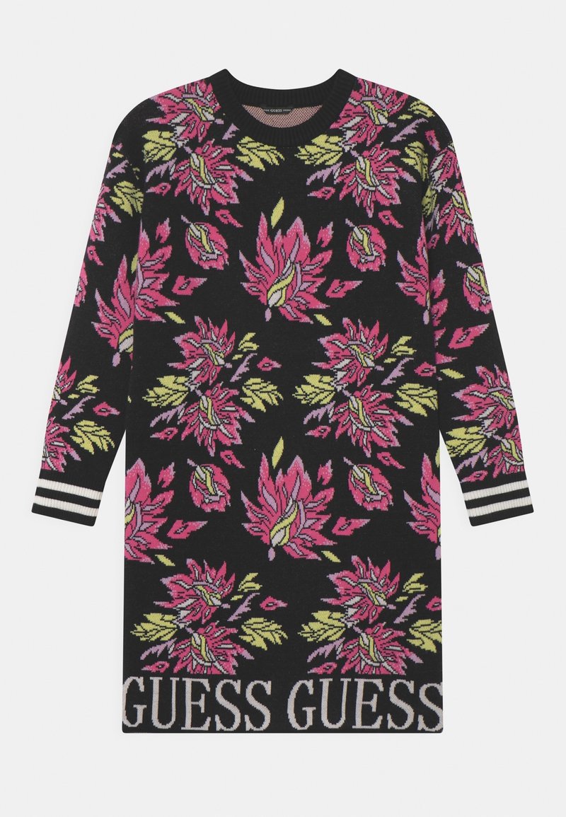 Robe-pull noire à manches longues avec motifs floraux roses et jaunes, poignets rayés, et logo "GUESS" en bas de l'ourlet.
