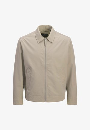 Jachetă beige deschis cu fermoar, guler ascuțit, material texturat, mâneci lungi și două buzunare frontale diagonale.