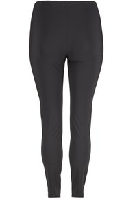 Leggings noirs extensibles avec une texture lisse, conçus pour épouser le corps, dotés d'une taille haute et sans coutures visibles.