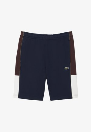 Pantalones cortos deportivos en color marino y marrón con cintura elástica, paneles laterales en blanco contrastante y detalle del logo en verde en la parte inferior izquierda.