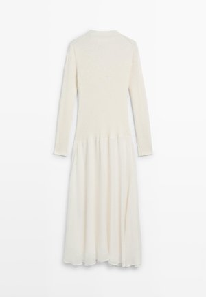 Langärmeliges Kleid mit einem gestrickten Oberteil in Cremefarben, das in einen fließenden, transparenten Rock übergeht. Strukturierter und leichter Stoff.