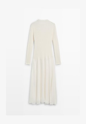Langärmeliges Kleid mit einem gestrickten Oberteil in Cremefarben, das in einen fließenden, transparenten Rock übergeht. Strukturierter und leichter Stoff.