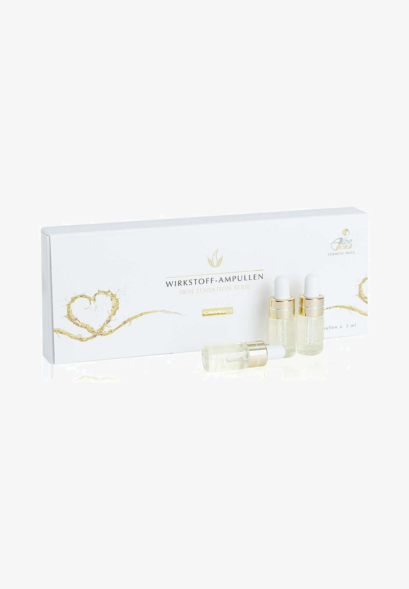 Boxed set of three clear glass ampoules with white droppers, gold accents, and white packaging featuring gold decorative elements and text.