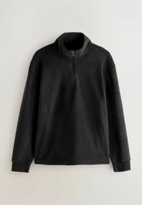 Mustaga fliisist poolsaabas, millel on kõrge krae ja poolpikkuselt lukuga. Ööbimisomadustega pikad varrukad ja soonikkoes mansetid. Pehme tekstuur, minimaalne disain.