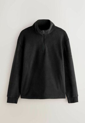 Czarny polarowy pulower z wysokim kołnierzem i zamkiem błyskawicznym na pół długości. Posiada długie rękawy i ściągacze na mankietach. Miękka tekstura, minimalistyczny design.