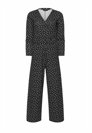 Combinaison noire à manches longues avec des pois blancs, col en V style portefeuille, taille ajustée et pantalons à jambes larges.