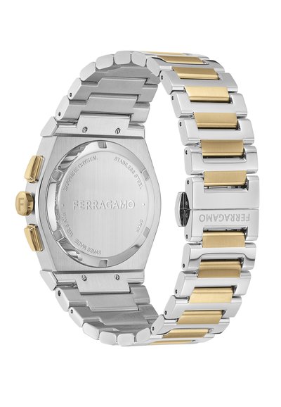 Sudraba un zelta nerūsējošā tērauda pulkstenis ar astoņstūru korpusu, divkrāsu saišu aproci un izteiksmīgu kroni. Aizmugurē redzams izceltā zīmola logotips.