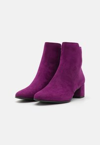 Purple suede ankle boots with a pointed toe and a mid-height block heel. Smooth texture and minimalistic design, featuring no visible embellishments.