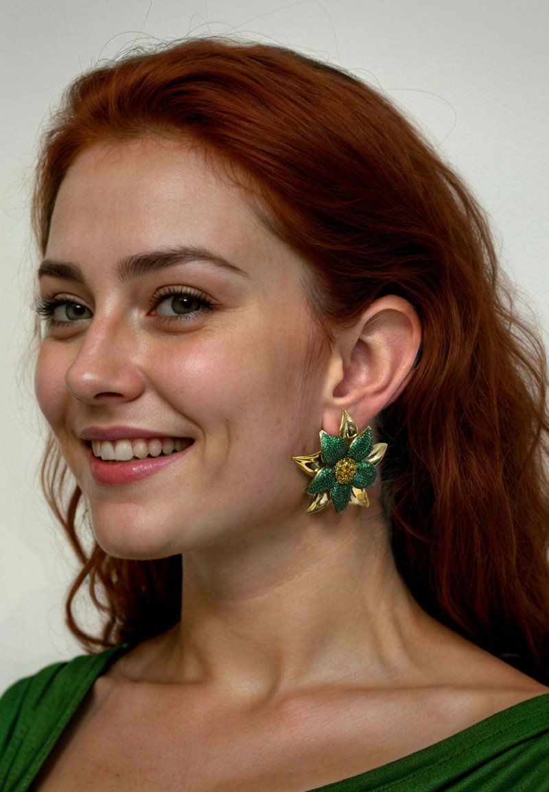 Green floral earrings featuring a gold base and textured green petals, accented with a central gold flower, worn by a model with red hair.