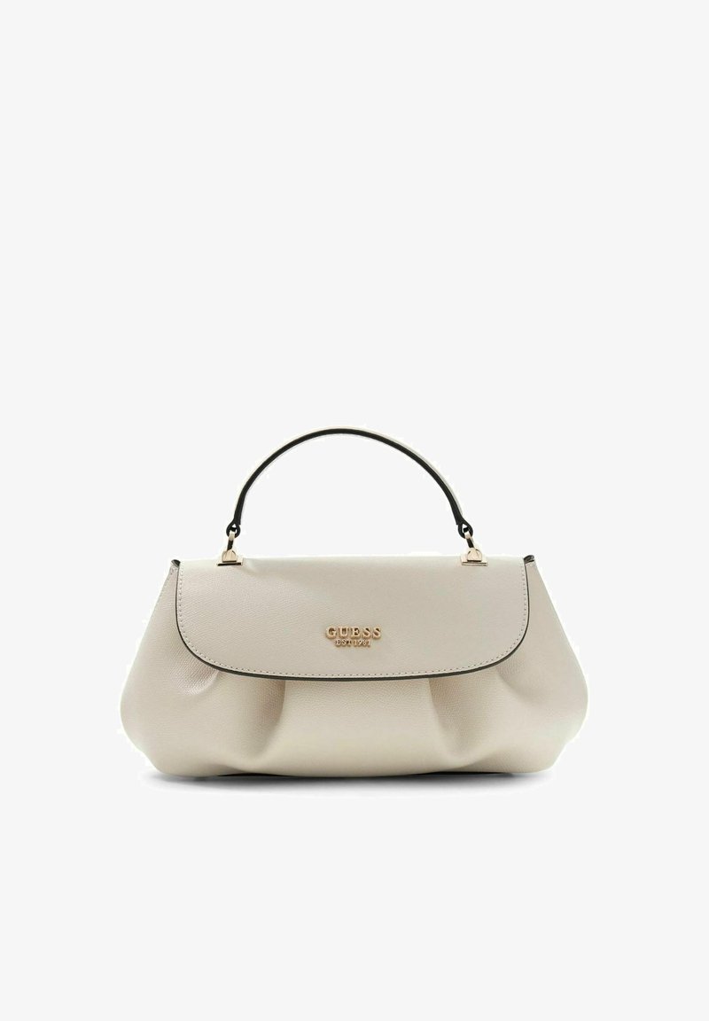 Sac à main en cuir beige avec poignée noire, logo doré "GUESS EST 1981" sur le rabat avant, structuré avec des plis doux à la base.