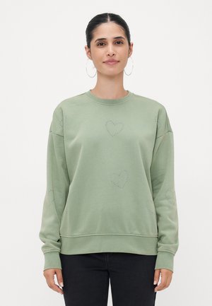 Lys grøn sweatshirt laget av mykt stoff, med hjerteformede nagle detaljer på fronten og ermene, i avslappet passform og ribbede mansjetter.