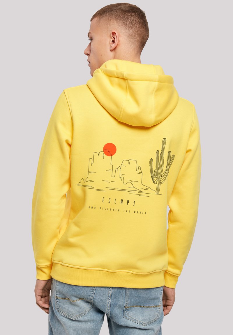 Yellow hoodie with a drawstring hood, featuring a graphic of mountains, a sun, and a cactus on the back in black and red. Casual fit.