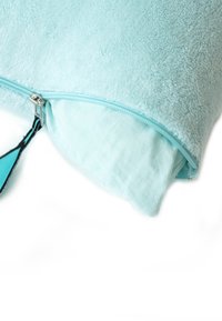 A light blue pillow with a soft, textured cover. Features a visible zipper with a black pull tab and contrasting inner fabric.