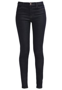 Mörkblå denim skinny jeans med hög midja, featuring femficksdesign, metallknappsstängning och minimal sömnadsdetalj.