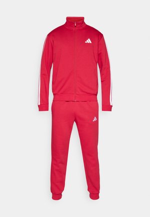 Roter Sport-Trainingsanzug aus Baumwollmischung, mit einer Reißverschlussjacke mit hohem Kragen, zwei weißen Seitenstreifen und Logoakzenten an Jacke und Hose.