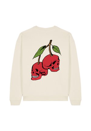 Sweatshirt crème avec un graphique de deux crânes rouges ressemblant à des cerises, avec des feuilles vertes sur une tige marron. Texture lisse et coupe décontractée.
