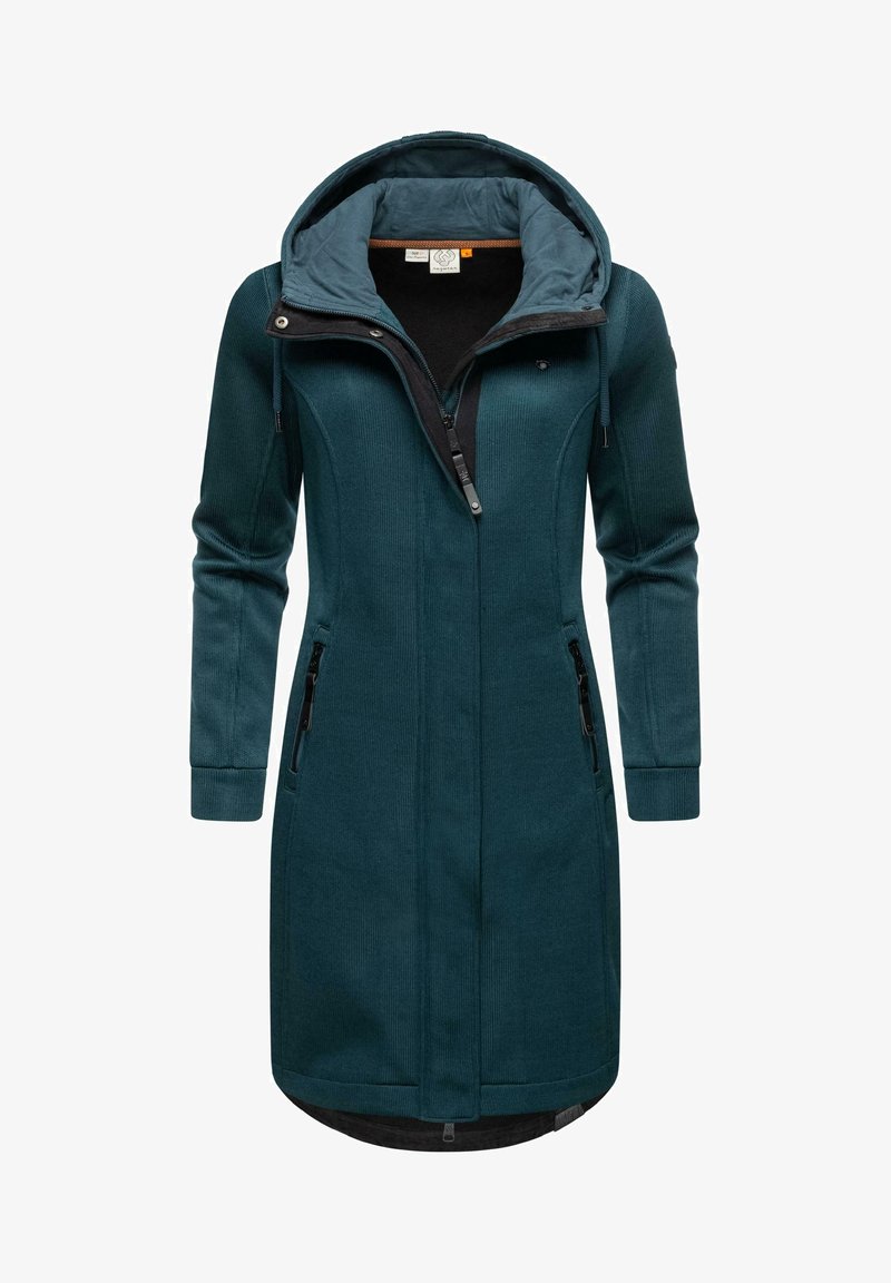 Soehune sinine pikk jope kapuutsi ja tekstuuriga kangast; omab kahte tõmblukkudega küljetaskut ja ees tõmblukku; mustad aktsendid kaeluses.