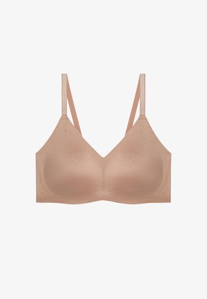 Light brown, seamless bra with a smooth texture, adjustable straps, and a simple design. No hardware or embellishments evident.