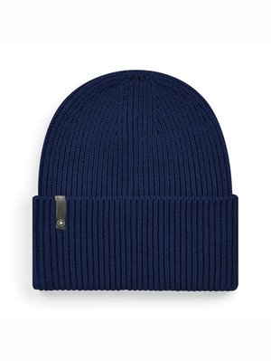 Navy knitted beanie with ribbed texture, fold-over cuff, and small metallic logo tag on the side. Soft, stretchable material.