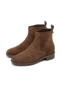 Botas de tobillo de ante marrón con un acabado suave, paneles laterales elásticos estriados y un tacón bajo tipo bloque. Presentan tiradores para facilitar su uso.