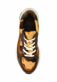 Brown and tan sneaker featuring a mix of textured leather and hair-on-hide. White laces and a rubber sole complete the design.