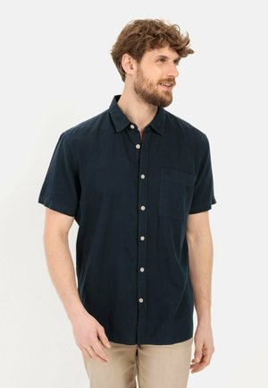 Kurzärmliges, knöpfbares Hemd in Marineblau, aus weichem Stoff, mit einer Brusttasche und leichten Knöpfen. Lässiger Schnitt, minimalistisches Design.