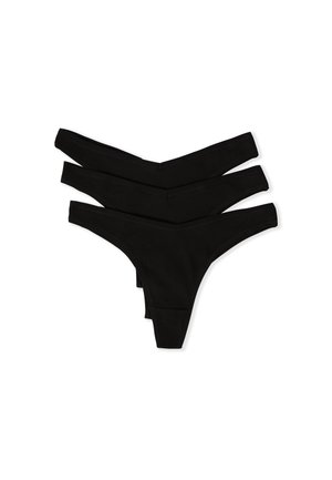 Tre pezzi di lingerie a brasiliana nera in tessuto a coste impilati su uno sfondo bianco.