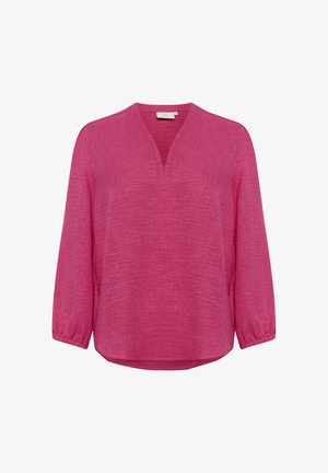 Fuksia roosa pikad varrukad tipuga V-kaelus ja tekstuuriga kangas. Omab kergelt pungitatud varrukasid ja hem, mis kumerdab külgedel ülespoole.