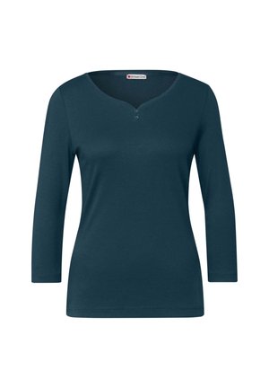 Dunkelblaugrünes Langarmoberteil mit V-Ausschnitt und drei Knöpfen am Kragen. Aus einem weichen, glatten Stoff gefertigt und mit taillierter Passform.