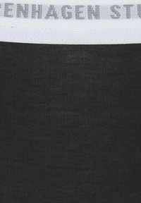Black fabric with a textured surface, featuring a white band at the top with light gray "Copenhagen Studio" text.