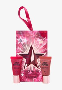 Saftiga Peptide läppbalsamset i röda rör, med en glänsande rosa stjärnformad låda, med stjärnexplosion design, hängande band och vegansk etikett.