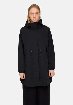 Black waterproof jacket with a hood, featuring elastic cuffs, drawstring waist, and side pockets. Minimalist design with no visible branding.