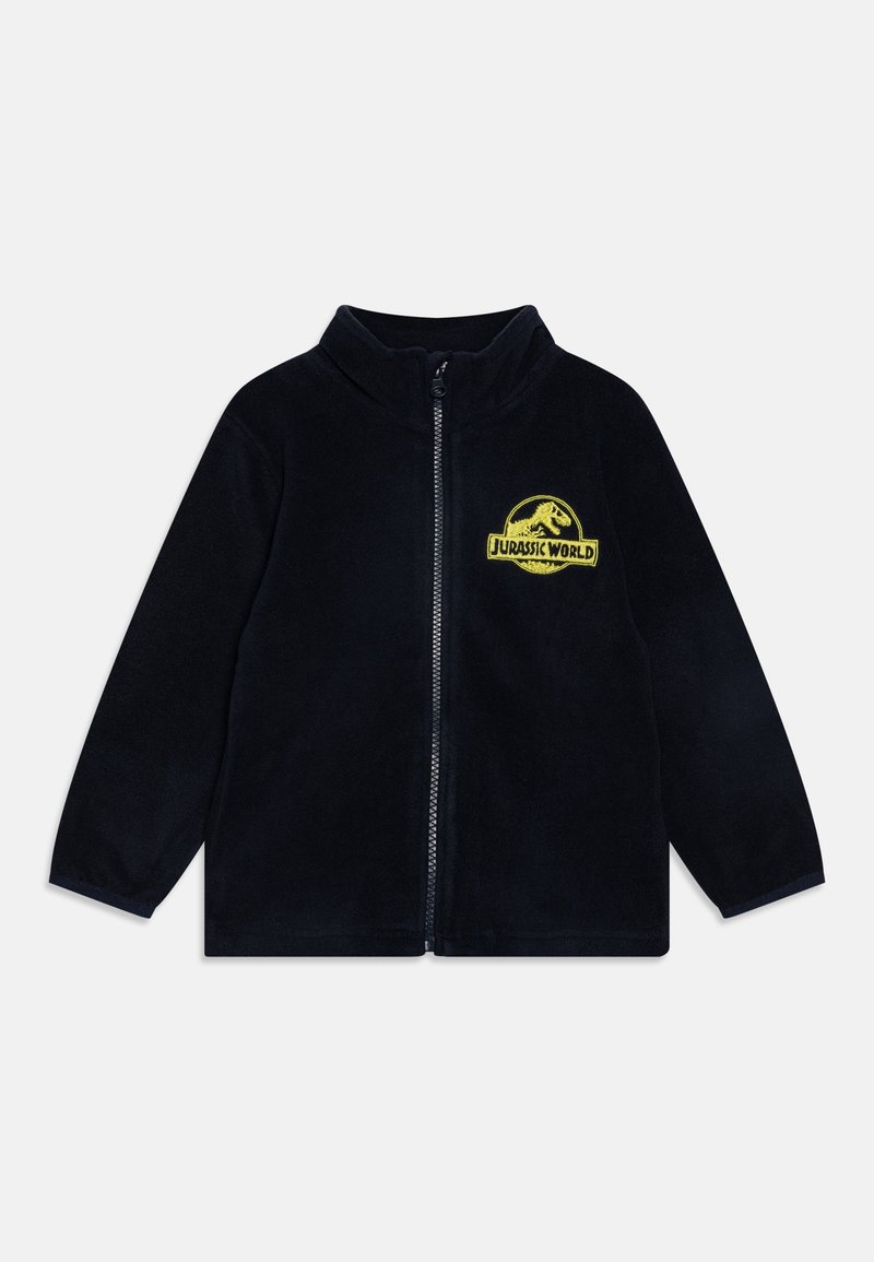 Veste polaire noire zippée avec manches longues et logo jaune Jurassic World sur la poitrine gauche.