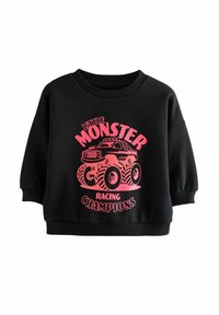Schwarzer Pullover mit kurzen, gepufften Ärmeln. Mit einem pinken Grafik eines Monstertrucks und dem Text "Little Monster Racing Champions."