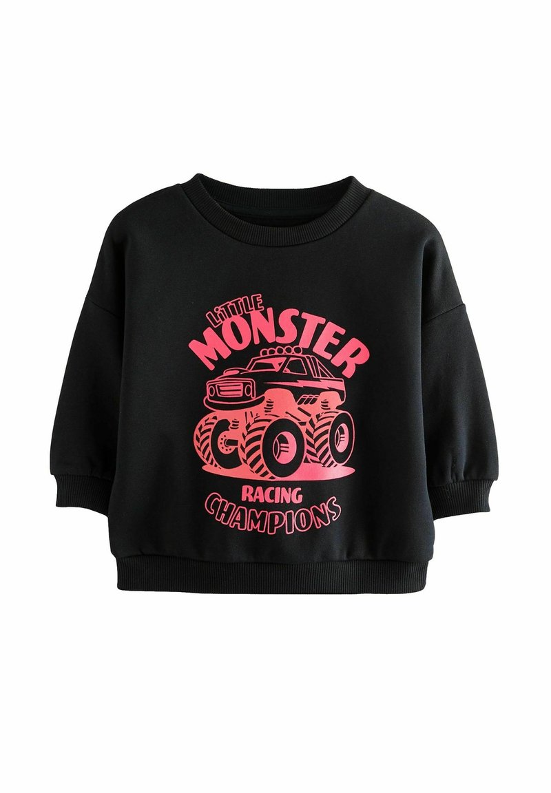 Schwarzer Pullover mit kurzen, gepufften Ärmeln. Mit einem pinken Grafik eines Monstertrucks und dem Text "Little Monster Racing Champions."
