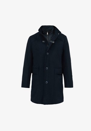Ciemnoniebieski wełniany płaszcz z kołnierzem stójkowym, z przodu zapinany na guziki i posiadający dwie kieszenie z przodu. Posiada zamek błyskawiczny oraz podszewkę dla ciepła.