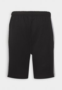 Shorts de sport noirs en tissu, dotés d'une taille élastique et de panneaux latéraux gris avec un détail textuel sur les côtés.