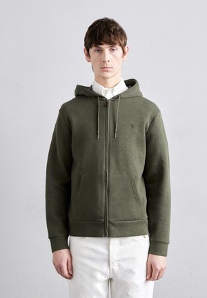 Olive green zip-up hoodie with a drawstring hood, kangaroo pockets, and a small logo on the chest; soft texture and fitted design.