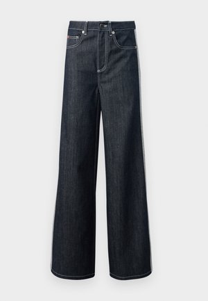 Mørkeblå vid jeans laget av denim. Funksjoner inkluderer knappelukking, fem lommer og kontrasterende hvite sømmer. Glatt tekstur.