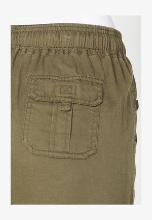 Olive green cargo shorts featuring an elastic waistband and a patch pocket on the back with a flap closure. Textured fabric.