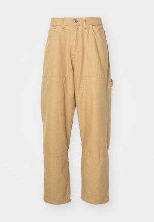 Beige cargo pants made of cotton blend fabric. Features multiple pockets, straight legs, and a button closure at the waistband.