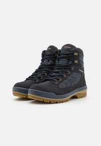 Dark blue hiking boots with suede and textile upper, rubber soles, lace-up design, gold hardware accents, and reinforced ankle support.