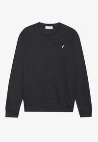 Black crewneck sweatshirt made of soft fabric, featuring a small gold emblem on the chest and ribbed cuffs and hem.
