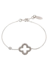 Silver bracelet featuring a clover-shaped charm adorned with small stones, delicate chain with a secure clasp, and a small tag.