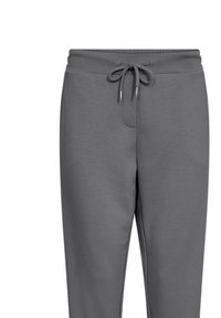 Grijze sweatpants met een koord in de taille, zachte textuur en een relaxed fit. Beschikt over een voorzak en een taps toelopend ontwerp.